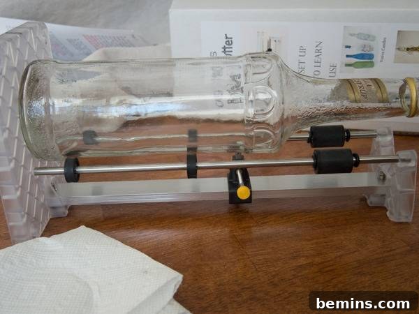 Which Bottle Cutter Reigns Supreme? A Definitive Review 43 A glass bottle is held up sideways with a contraption.