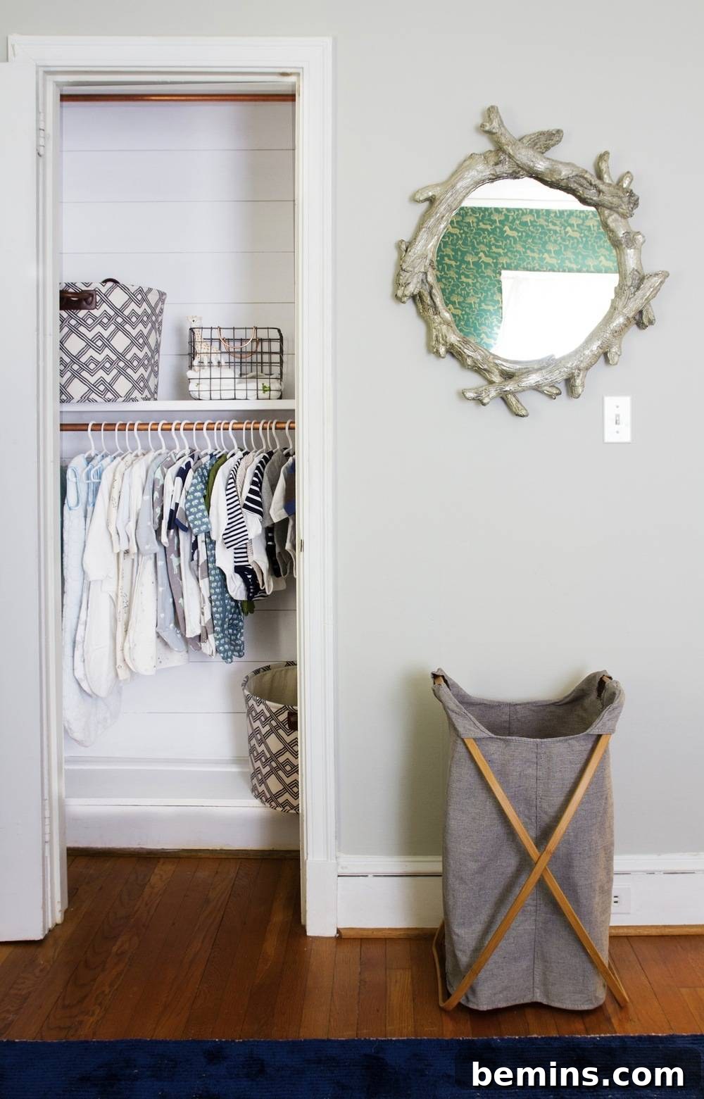 A rustic woven basket sits neatly under a window, near an open closet showcasing organized baby essentials, blending practical storage with a cozy, inviting aesthetic.