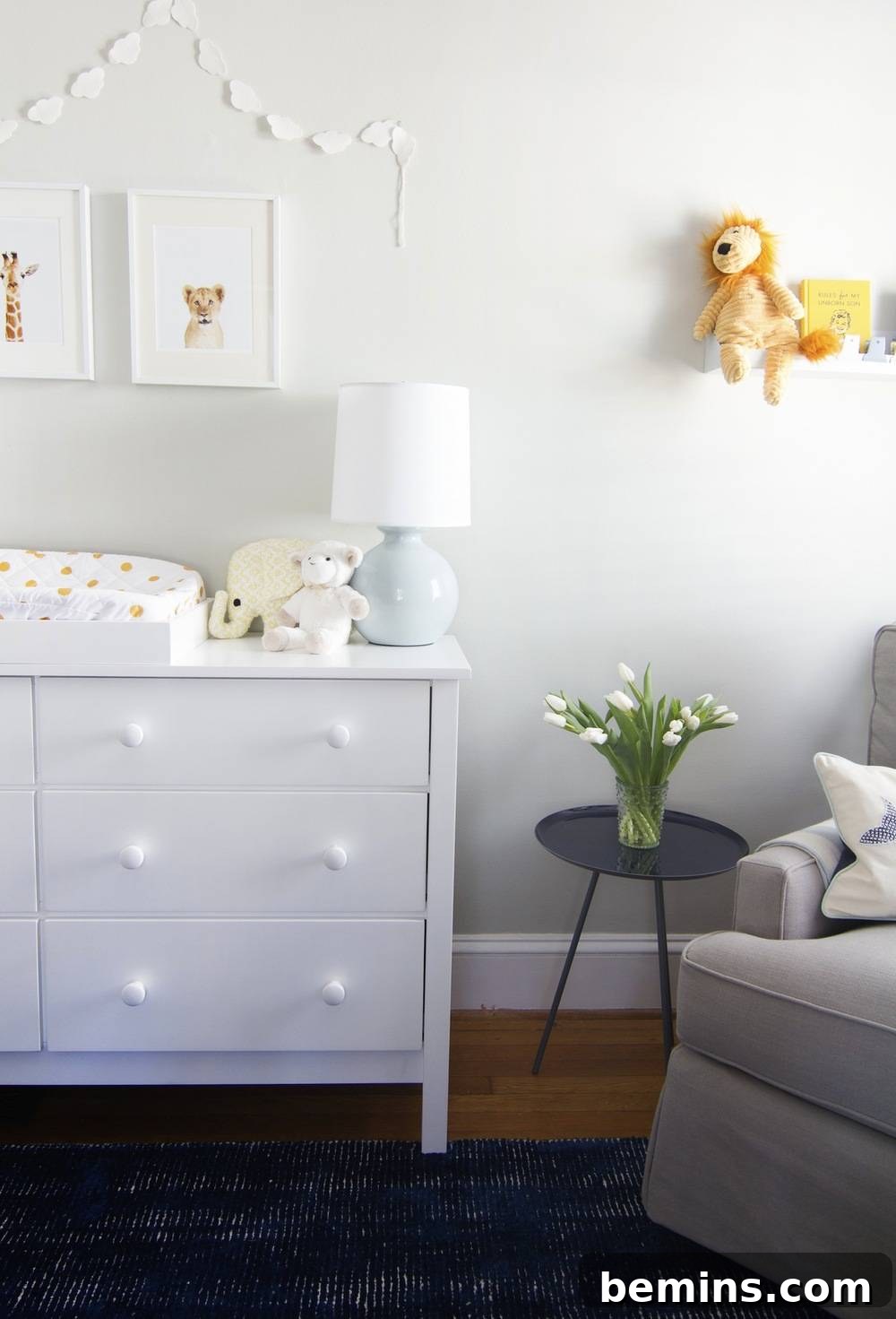 A beautifully illuminated baby boy's nursery, painted in a serene white and furnished with elegant white furniture, creating a bright, spacious, and inviting atmosphere ready for peaceful moments.
