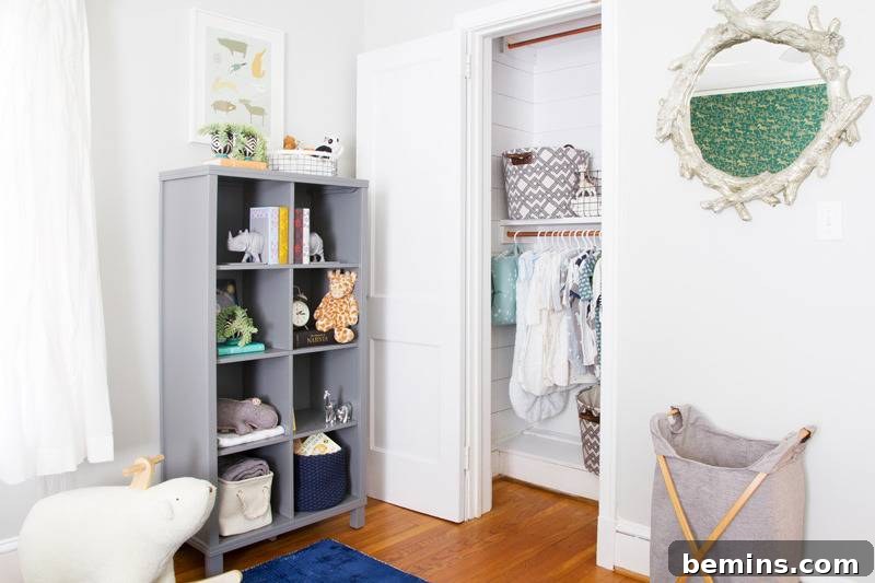 A bright, airy room featuring a modern gray shelving unit filled with carefully curated decor and a stylish gray hamper, providing both storage and aesthetic appeal.