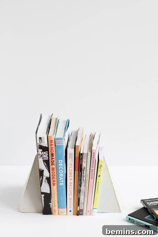 DIY Geometric Concrete Bookends from Recycled Cardboard 16 Geometric concrete bookends holding up books.