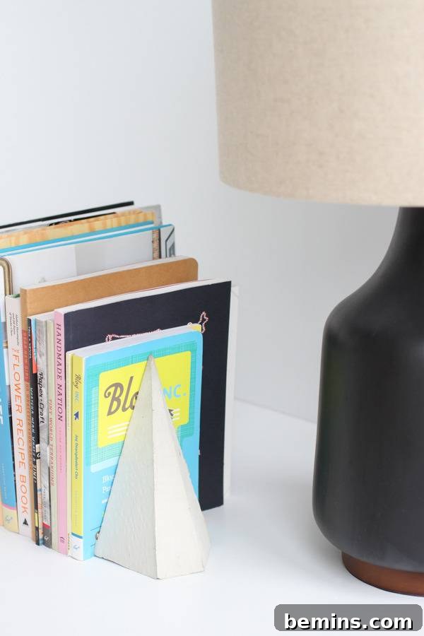 DIY Geometric Concrete Bookends from Recycled Cardboard 17 Books next to a black vase.