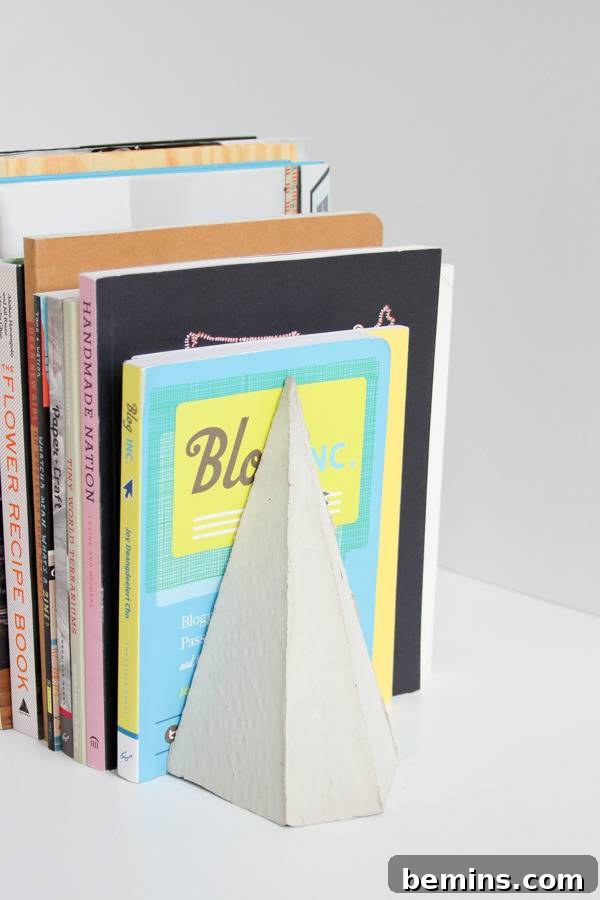 DIY Geometric Concrete Bookends from Recycled Cardboard 3 A handcrafted concrete bookend constructed with cardboard elements.
