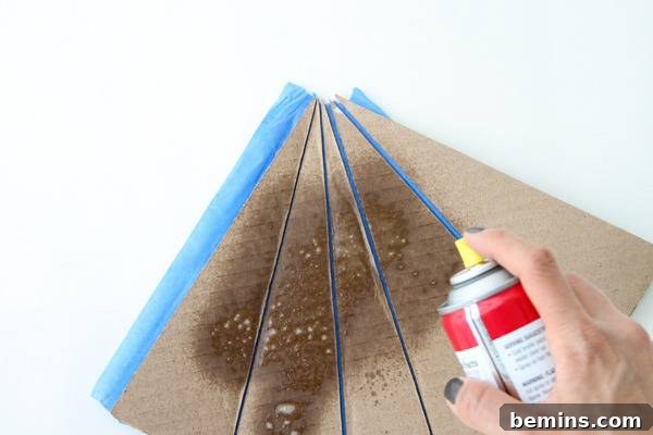 DIY Geometric Concrete Bookends from Recycled Cardboard 8 Spraying cardboard with cooking spray.