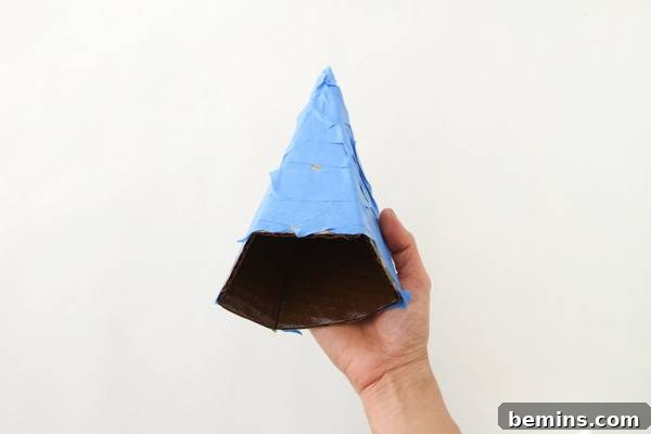 DIY Geometric Concrete Bookends from Recycled Cardboard 9 A light blue and black triangle sculpture.