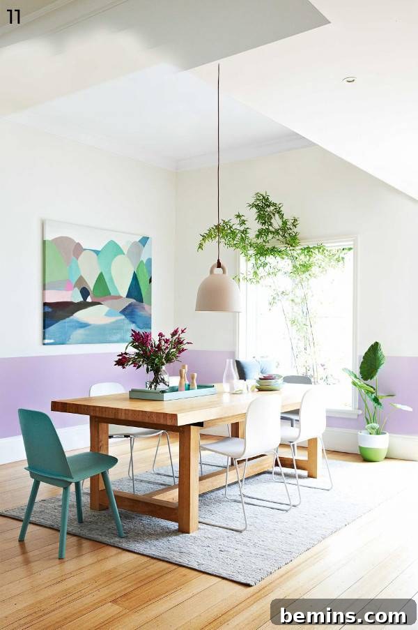 Pastel room with wooden table and chair, potted plants, and wall art.
