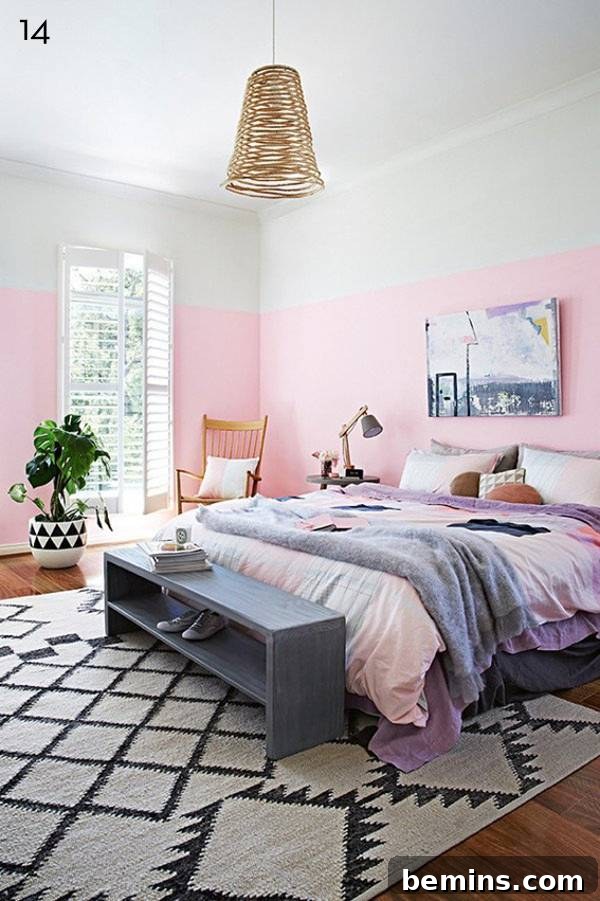 Bedroom with pink and white walls and a black and white rug.