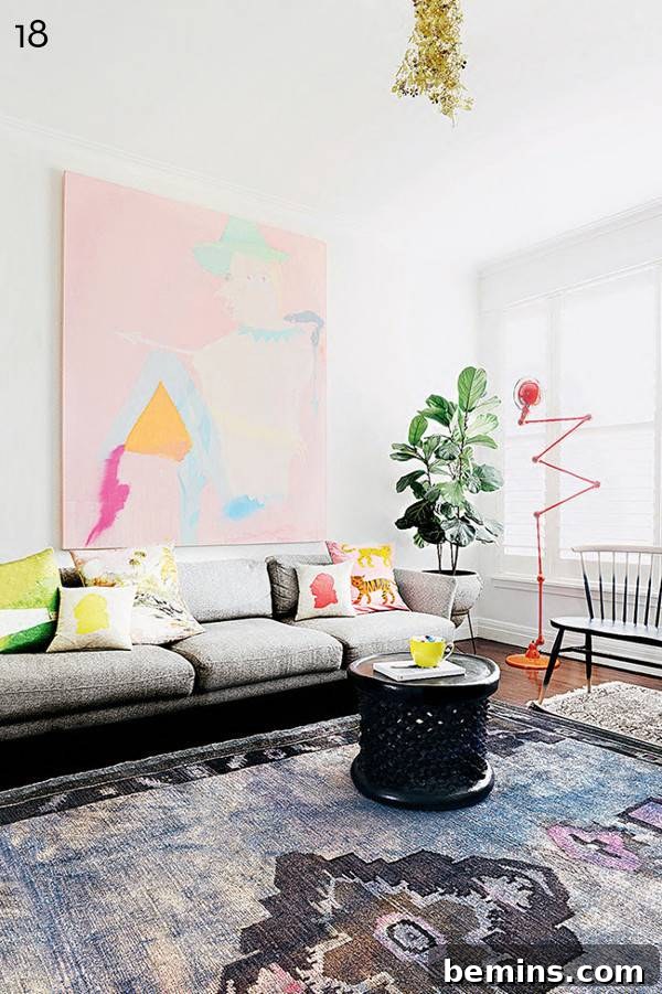 Silver couch with pastel decor.