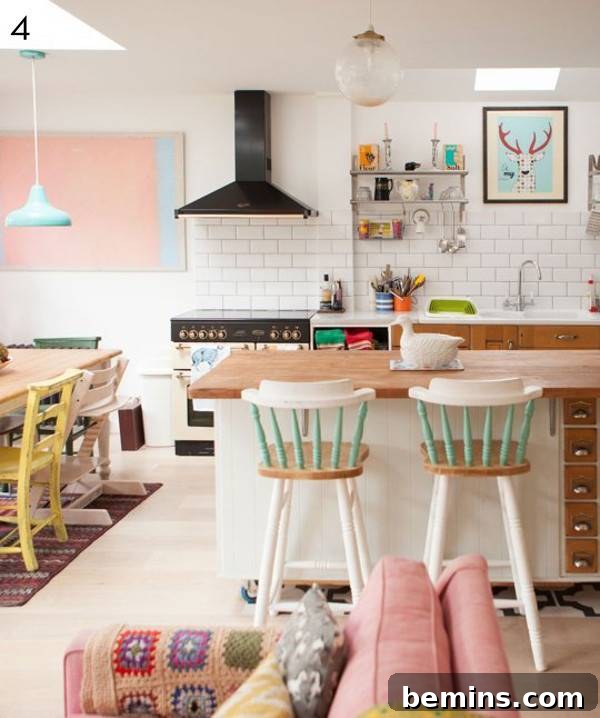 Dining room with cream chairs and a pink couch.