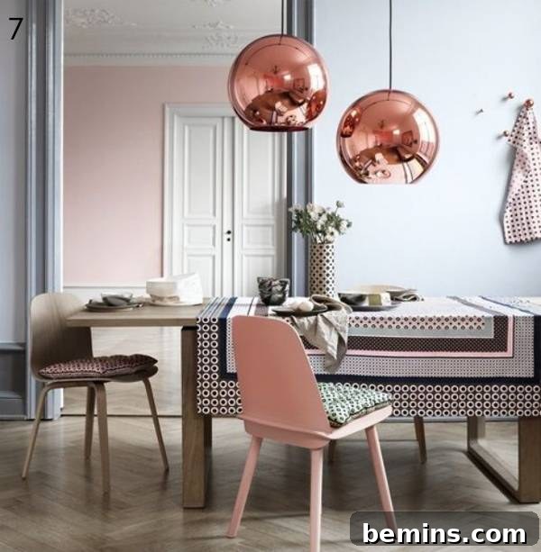 Rose gold pendant lights over a dining table.