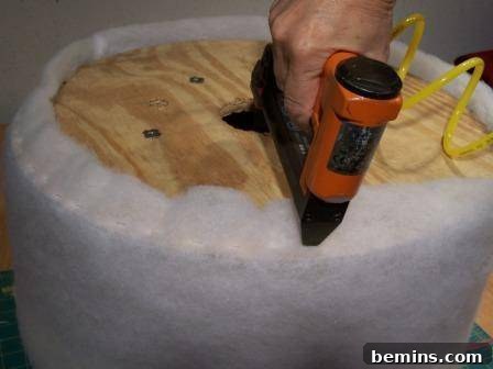Upcycled Wooden Spool Ottoman in Light Green 8 Man using a drill