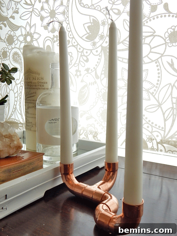 White candles in copper candlesticks