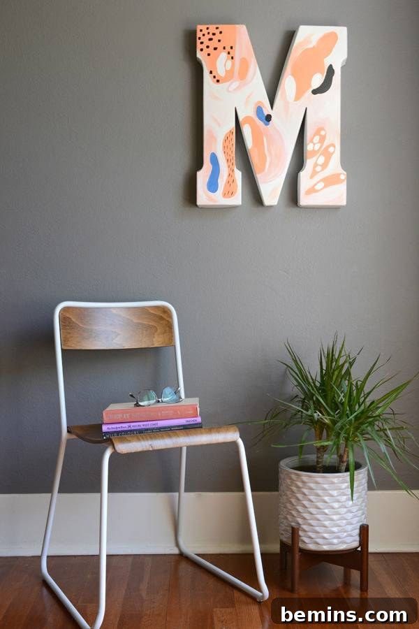 A finished abstract 'M' shaped wall art piece is gracefully hanging on a light-colored wall, showcasing the project's potential.