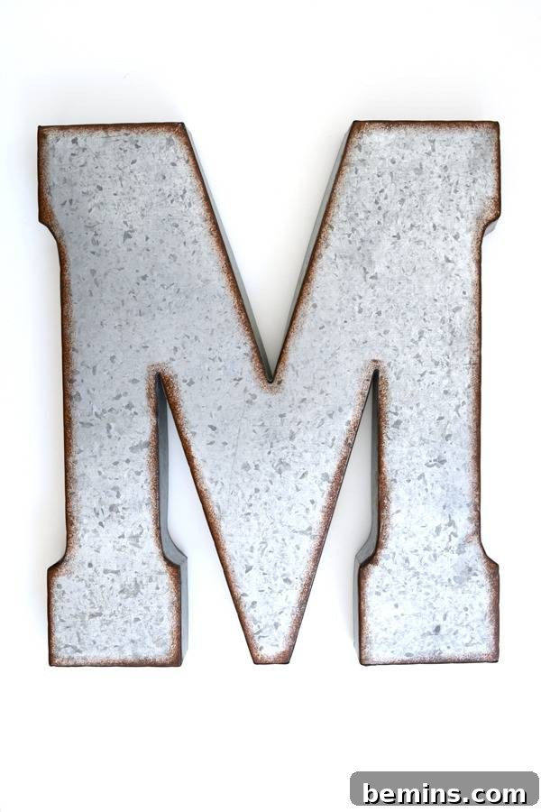 The bare metal letter M is proudly displayed against a simple white background, ready for its artistic transformation.