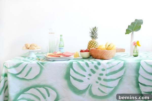 DIY Tropical Leaf Tablecloth Project 3 A vibrant tropical leaf tablecloth adorning a table set for a meal.