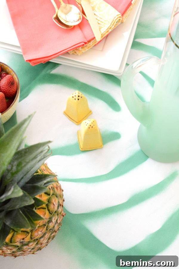 DIY Tropical Leaf Tablecloth Project 4 A pineapple and colorful decorations enhancing a tropical-themed setting.