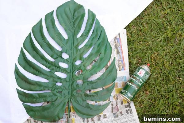 DIY Tropical Leaf Tablecloth Project 6 A large tropical leaf placed on newspaper in preparation for painting.