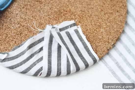 Crafting Cork Creations: Simple Art with Plant Mats 5 Folding the fabric over the back of the cork mat and securing it with adhesive.