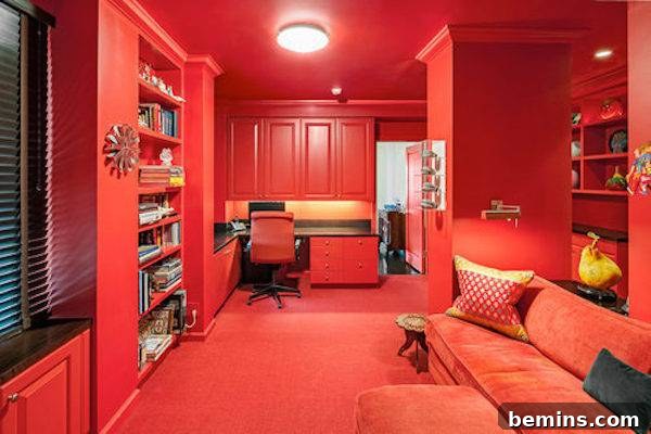 A room entirely done with red and several book shelves on the walls.
