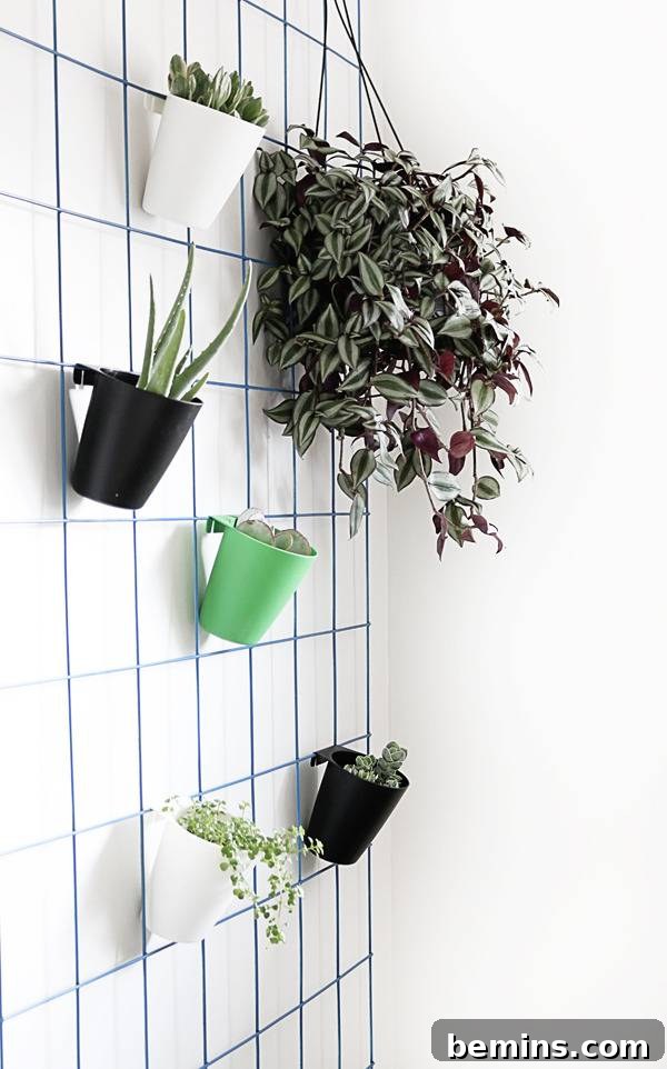 Vibrant Green Plants on a Blue Wire Mesh Wall