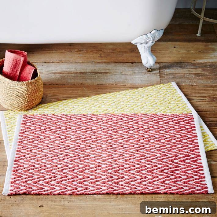 Woven red bath mat on top of a yellow one in a bathroom