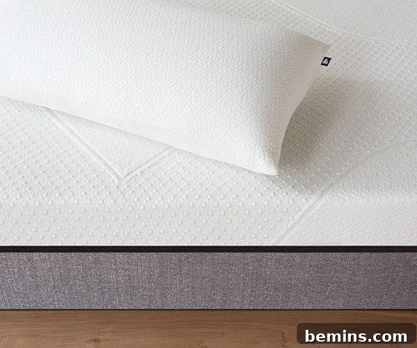 A pillow is sitting on a bed above a wooden floor.