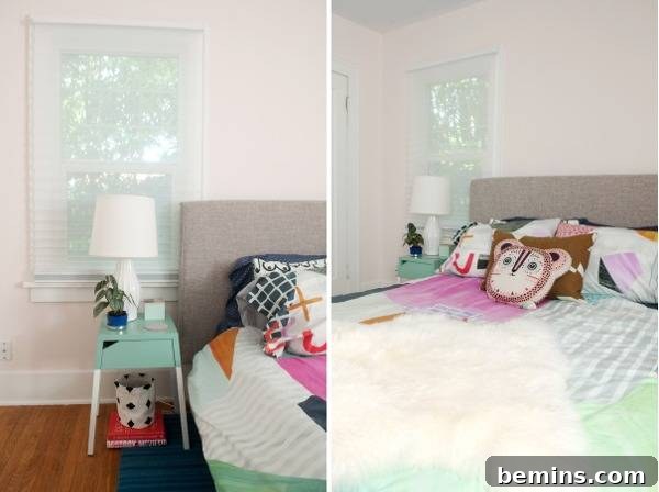 A teal bedside table with a lamp, positioned next to a bed with playful pillows.