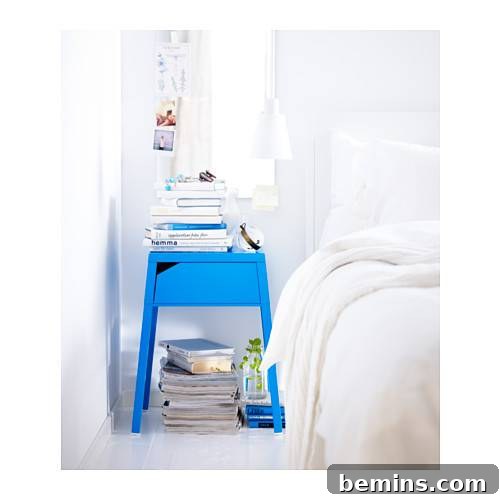 From Bland to Brilliant: 13 Colorful Bedroom Decor Ideas 6 A bright blue IKEA nightstand adds a refreshing pop of color to an all-white bedroom, creating a vibrant contrast.