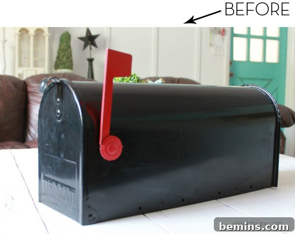 Black mailbox on a wooden table, showcasing a simple yet elegant mailbox style.