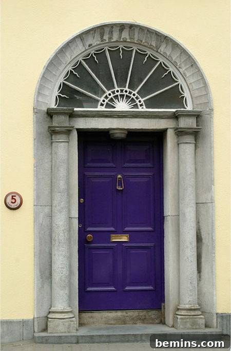 A purple door under a grey archway, creating a sophisticated and mystical entrance.