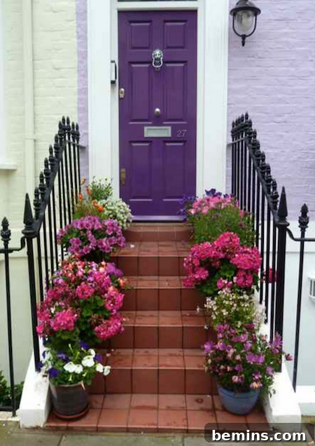 Red brick steps leading up to a purple door, flanked by potted flowers, creating a vibrant and elegant entrance.