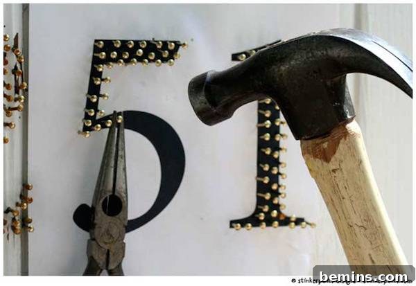 A hammer is nailing tacks into the number 51.