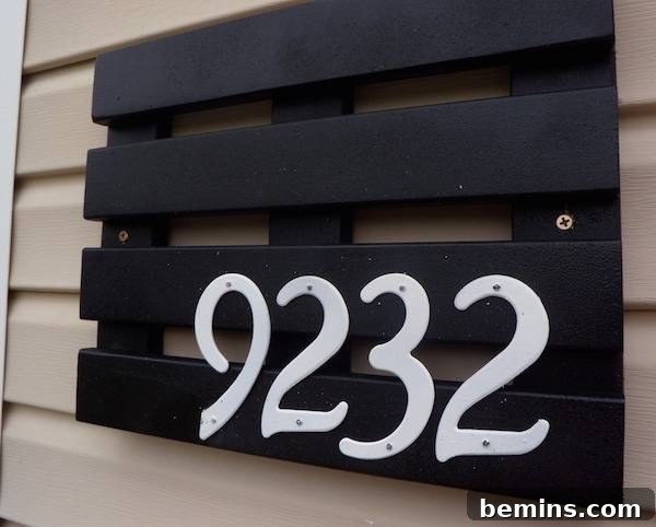 The number 9232 is written in white paint on a black pallet.