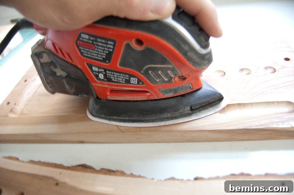 Man Sanding a Cutting Board