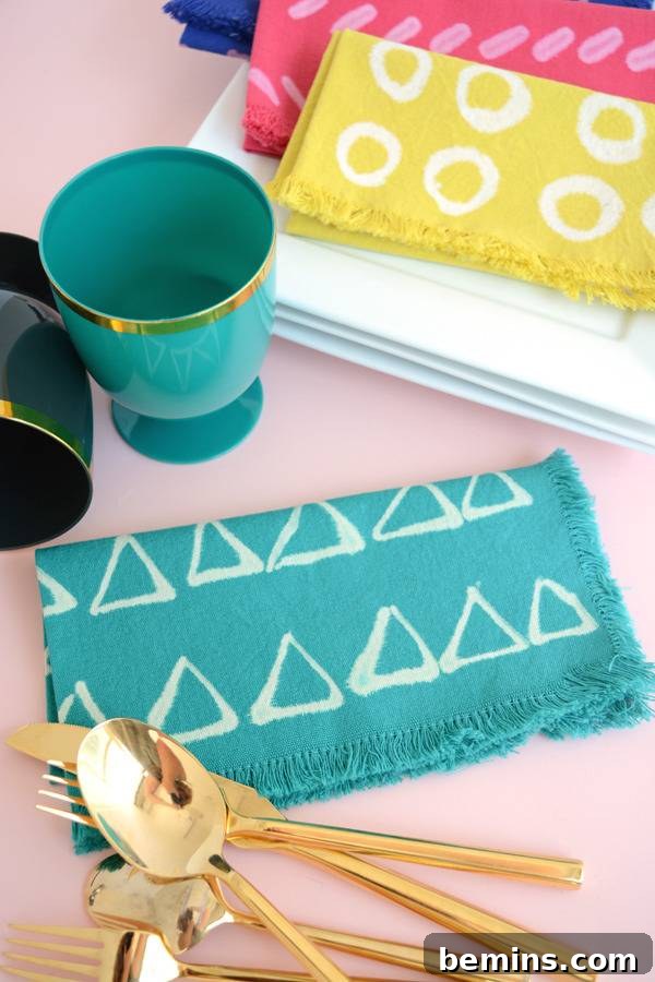 DIY Bleach Stenciled Geometric Napkins 11 Colorful fabrics are next to a blue mug and gold silverware.