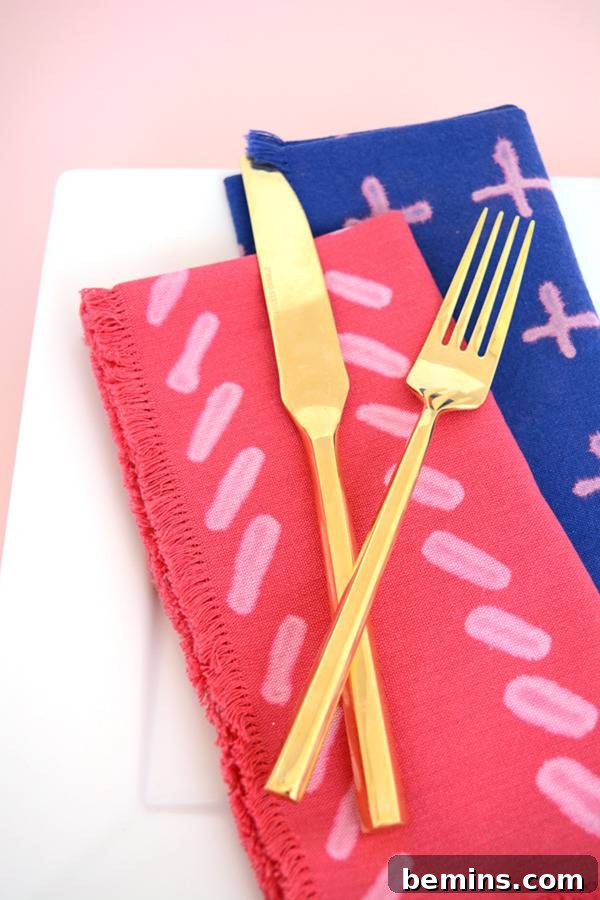 DIY Bleach Stenciled Geometric Napkins 12 Garden silverware are on three colorful towels.