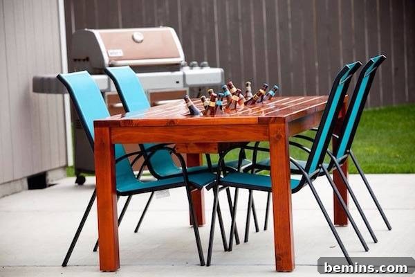 An outdoor table and chairs near a grill.