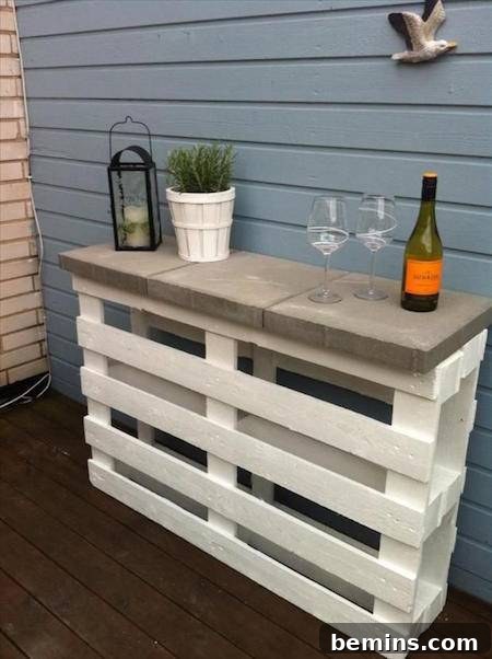 A white pallet with a stone on it is being used for a table.