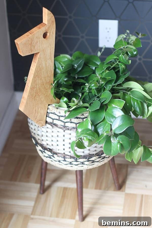 Close-up View of the Whimsical Llama Planter with a Green Plant