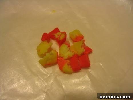 Candy corn fondant pieces are on a plastic wrapper for decoration.