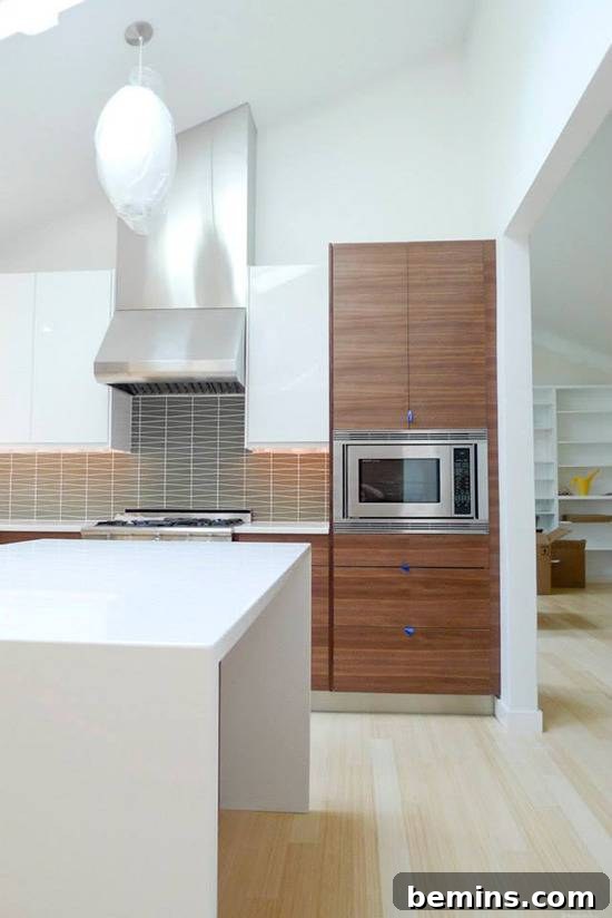 Modern kitchen featuring custom walnut cabinet fronts from SemiHandmade, fitted onto IKEA frames for a high-end look.