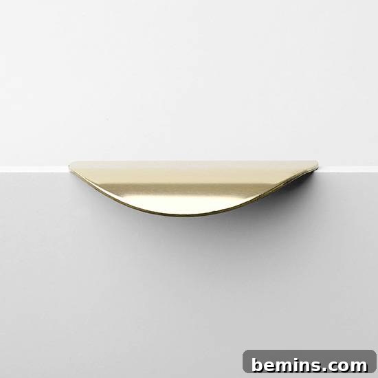 Detail shot of a modern cabinet enhanced with a sleek, designer SUPERFRONT handle in a metallic finish.