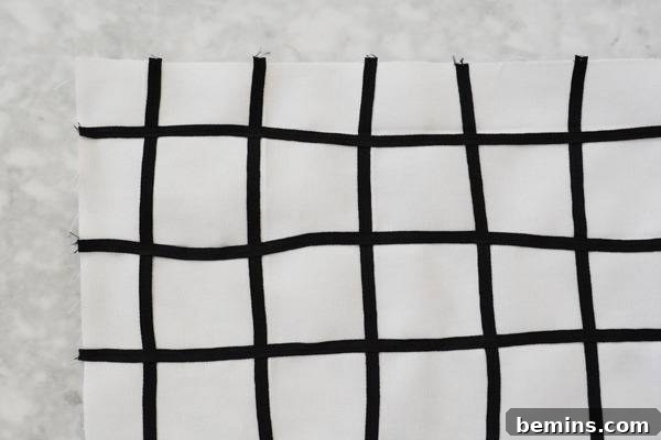 Stylish Geometric Pillows Easy DIY Guide 13 An overhead view of the pillow cover assembly, showing the front panel and two overlapping back panels pinned together for sewing.