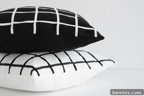 Stylish Geometric Pillows Easy DIY Guide 4 Two geometric pillows, one black with white grid and one white with black grid, stacked artfully to inspire modern decor.