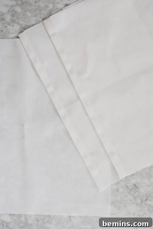 Stylish Geometric Pillows Easy DIY Guide 7 Three perfectly cut pieces of white cotton duck cloth – one square and two rectangles – ready for a DIY pillow project.