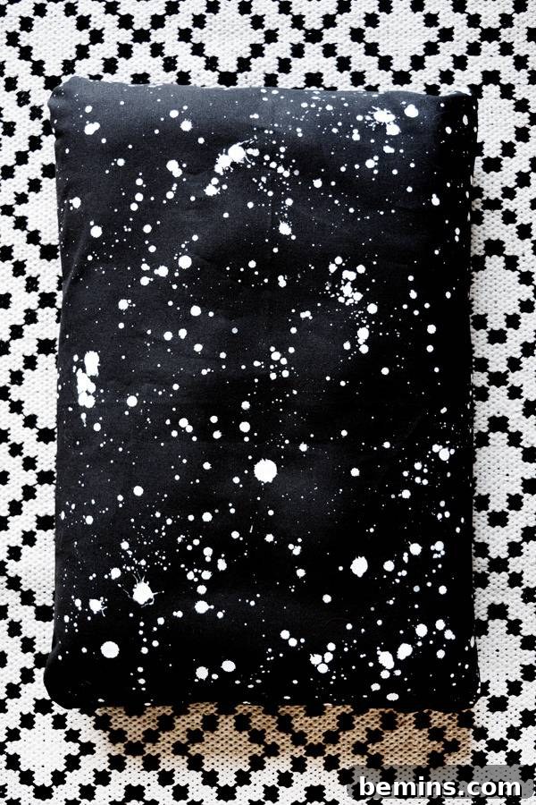 Pet bed in black cloth with white dots.