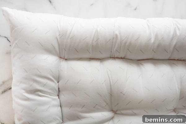 The corner of a fluffy white pet bed.
