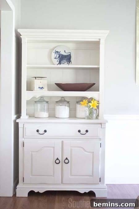 A wooden cabinet adorned with charming glass jars, adding a touch of rustic elegance.