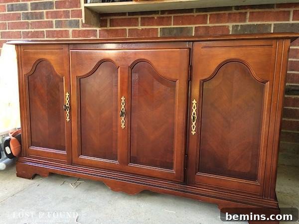 An entertainment table with four doors positioned in front of a brick wall, ready for a stylish update.