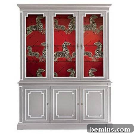 A gray cabinet with white accents and a red interior featuring captivating zebra decorations.